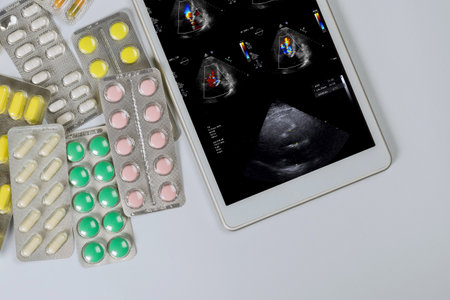 Doctor on the digital tablet checks the results echocardiography ultrasound of the heart examination to prescribe effective treatment in medical officeの写真素材