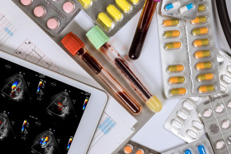 Using a digital tablet device, the doctor checks results of echocardiography ultrasound examination...
