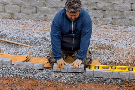 Construction workers for sidewalk consisting of stone concrete paversの写真素材