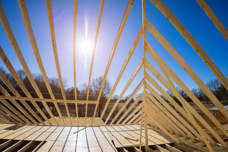During construction of new stick home wooden roof beam was constructed from an adjacent framework frame made from trusses.の写真素材