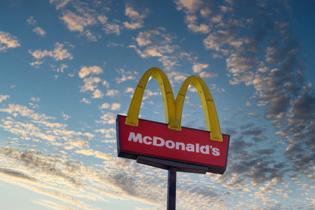 January 10, 2023 Atlanta, GA USA On a sunset sky background, you can see the sign of Mc Donalds fast food restaurantのeditorial素材