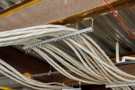 Electrical wires in new apartment building complex were laid and installed on ceiling of building
