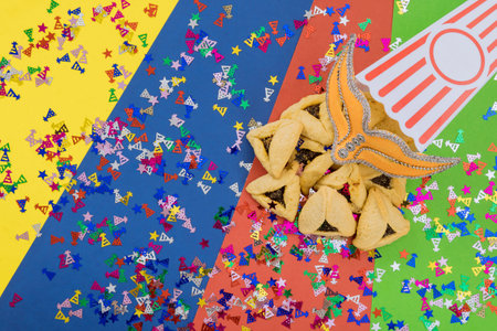 Jewish holiday of Purim with cookies, tallit, carnival masks, and noisemaker hamantaschen celebration symbols for Jewish celebrationの写真素材