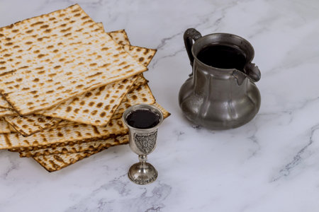 Passover consists of kosher unleavened matzah bread and kosher kiddush wine for Pesachの写真素材
