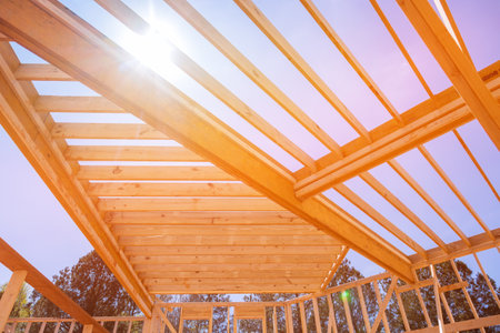 An underlying framing beam provides support for layout of joists in newly constructed wooden structure.の写真素材