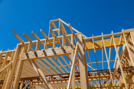 New residential under construction beams framing structure home wooden building frame on...