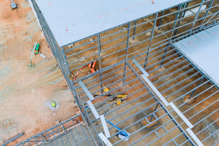 During construction of an industrial warehouse building, steel frames will be used for trussesの写真素材