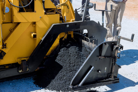 Performance asphalt pavers steam road rollers during one of stages road new road during construction...