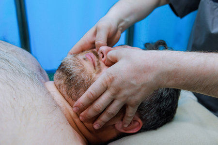 Manual therapist specializes in anti-aging face massages to improve skins elasticity reduce signs of aging.の写真素材