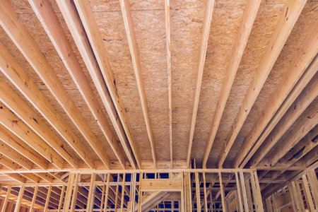 During construction of framing beam layout joists supports truss framework for wooden new houseの写真素材
