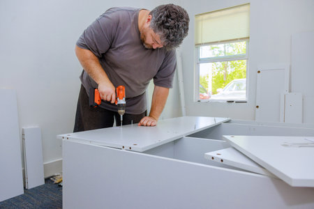Carpenter was assembling furniture closet cabinets that needed to be installed
