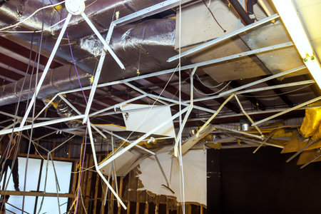 Reconstruction process of interior buildings includes removal of old ceiling through ceiling works.の写真素材