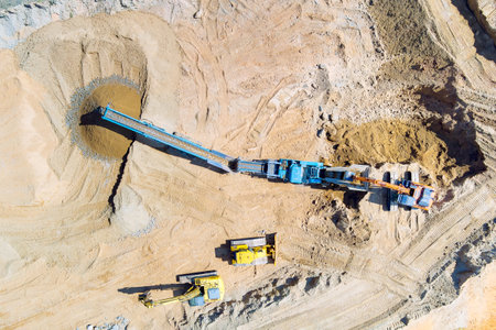 Gravel quarry mining with cone rock crusher for processing crushed graniteの写真素材
