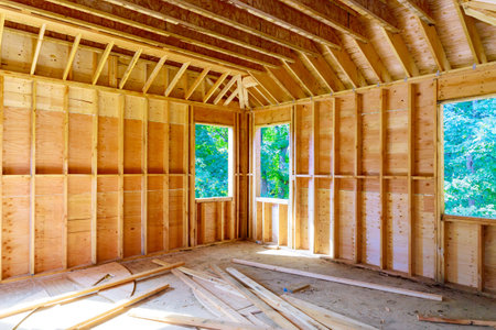 Construction underway interior view of new unfinished house with wooden beams