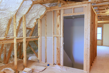 Spray foam insulation is used to insulate wall of an under construction site new home