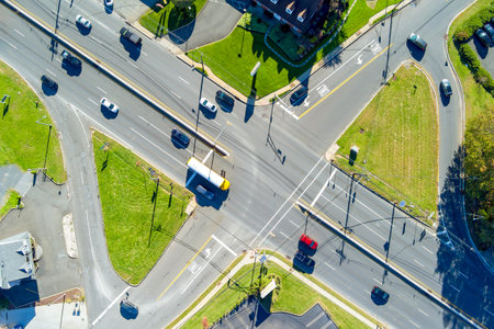 An aerial view of road intersection with heavy traffic moving during rush hour