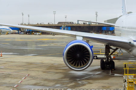 Several passenger planes are being serviced by ground services before next takeoff near boarding gate bridge at airportの写真素材