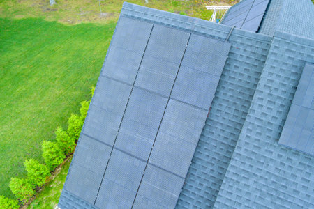 Roof of house has solar panels installed on top it