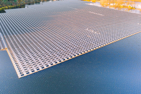 Solar panels are floating in large water pond are being used to generate electricity from sunlightの写真素材