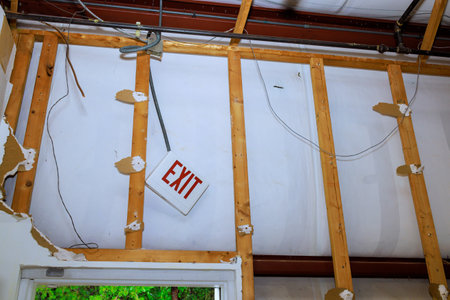 Process of removing old, damaged plasterboard drywall during house reconstructionの写真素材