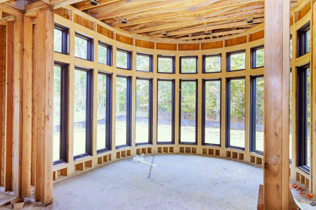 New unfinished residential home under construction framing of wood support beamの写真素材