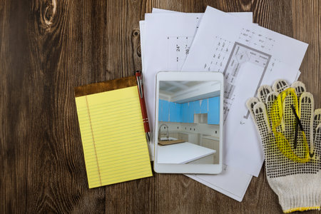 Remodeling kitchen with cabinets plan blueprint for an architectural engineer on tableの写真素材