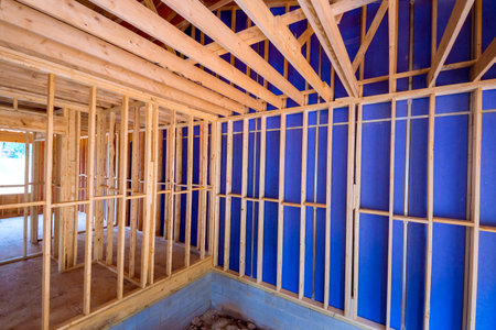 Construction during are assembling wooden beams to form framework of a house.の写真素材