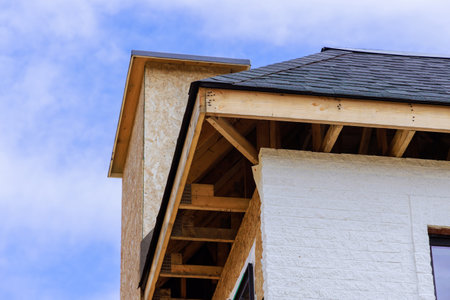 As house is under construction, joist framework gutter holders soffit fascia trim is being installed