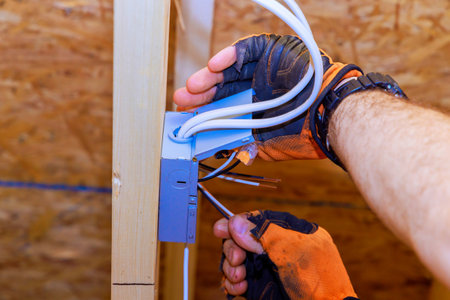 Installation of power junction box for LED recessed ceiling lights by an electrician during...