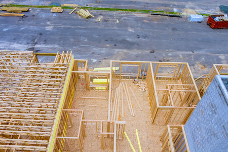 In residential construction project, unfinished wood frames are used during construction of new...