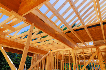 Building of wooden roof beams from trusses rafters with joistsの写真素材