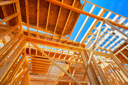 Framework for new home being constructed with wooden trusses, post beams