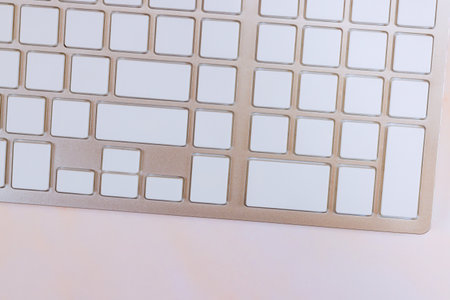 Computer keyboard with blank buttons is white without any inscriptions