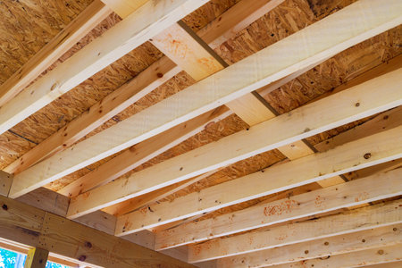During construction of new home, wooden frame beams are used to frame roofing trusses