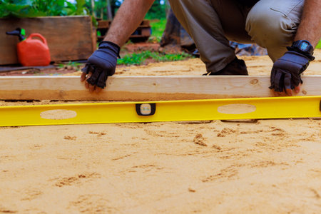 Sand leveling before installation of new swimming pool in backyard