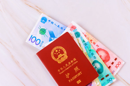 Passport issued by People Republic of China with Chinese yuan cash money in various denominationsの写真素材