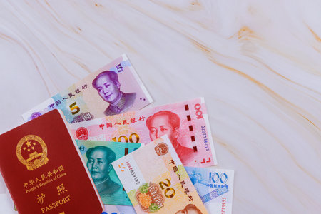 Passport People Republic of China containing Chinese cash yuan money in various denominations.の写真素材