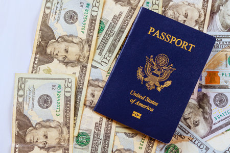 US passport on top of US currency American dollar banknotes that are different in denominationの写真素材