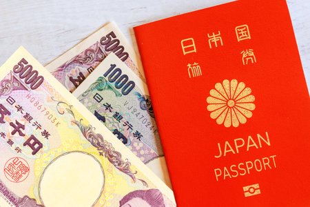Japan passport, Japanese yen money banknotes, cash issued by Nippon Ginko Bankの写真素材