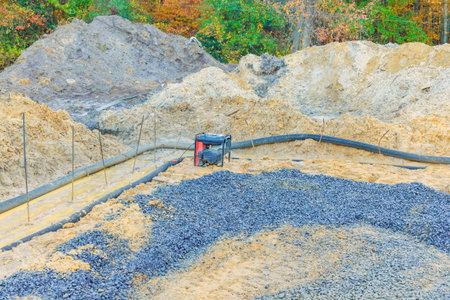 Preparation of ground foundation to installation formwork needed for pouring concrete at...