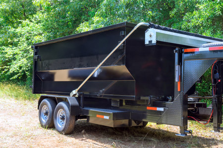During transportation to recycling center, truck lorry is unloading container dumpster of...
