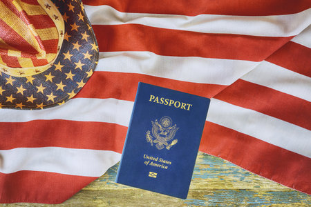 Over American flag is American passport, which represents citizenship naturalizationの写真素材