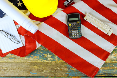 Labor Day celebration with safety gear flag of United States of America against rustic wooden backdropの写真素材