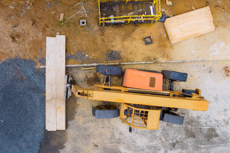 Forklift operator hanging stacker load wooden materialsの写真素材