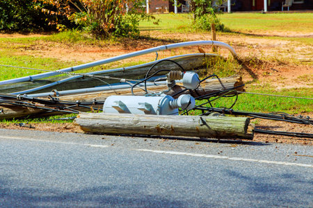 Several broken power lines lie crashed wires on ground following storm hurricaneの写真素材