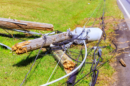 In aftermath of violent tornado, crashed power lines lie with broken wires on ground