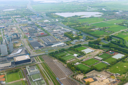 This aerial view of city Amsterdam, Netherlands shows over rooftops in cloudy weather conditionsの写真素材