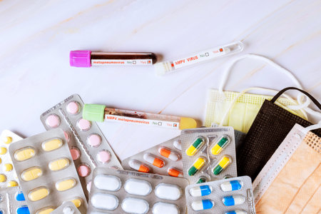 Various pills blood samples test tubes are arranged with surgical masks, use in healthcare settings...