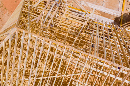 Construction workers collaborate to erect wooden framework new building in construction site