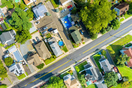 View captures sunny suburban neighborhood with houses, pool, green spaces at Sayreville American town New Jerseyの写真素材
